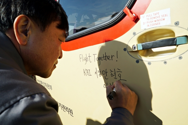 지난 4일 안현호 KAI 사장이 초도비행시험을 마친 국산 제작 소형민수헬기 시제기에 기념 서명을 하고 있다. (사진제공=KAI)