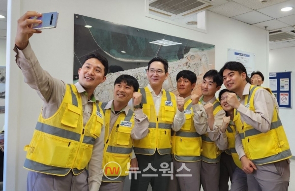 이재용(가운데) 회장이 지난해 12월 삼성물산이 참여하는 UAE 바라카 원전 프로젝트 건설 현장을 방문해 직원들과 기념사진을 찍고 있다. (사진제공=삼성전자)