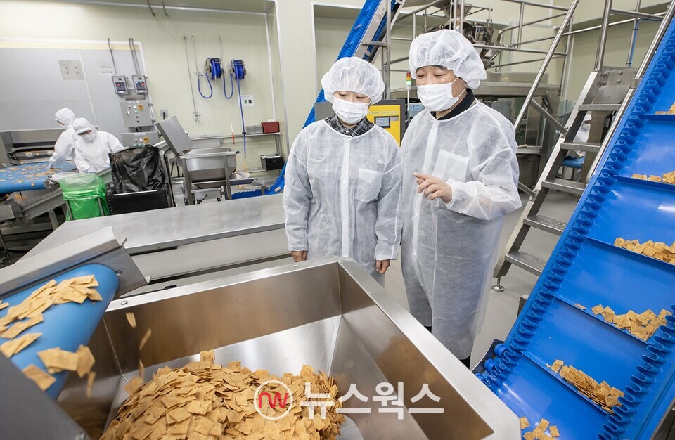 전라남도 여수에 위치한 식품기업 '쿠키아'에서 삼성전자 스마트공장 담당자(오른쪽)와 쿠키아 직원이 두부과자 품질 상태를 점검하고 있다. (사진제공=삼성전자)