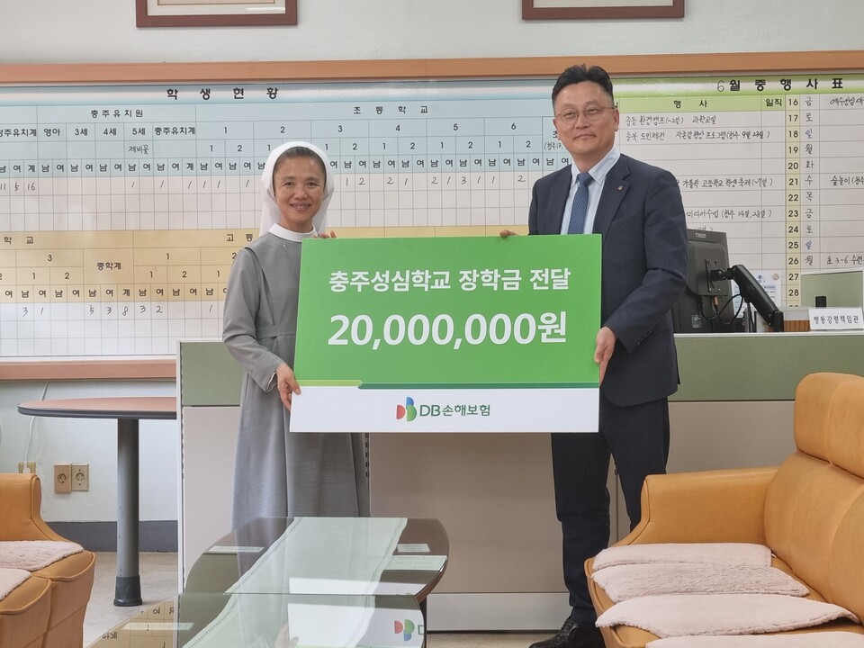 지난 15일 충주성심학교에서 열린 장학금 전달식에서 문진욱 DB손해보험 본부장(오른쪽)과 홍향순 교장수녀가 기념촬영을 하고 있다. (사진제공=DB손해보험)