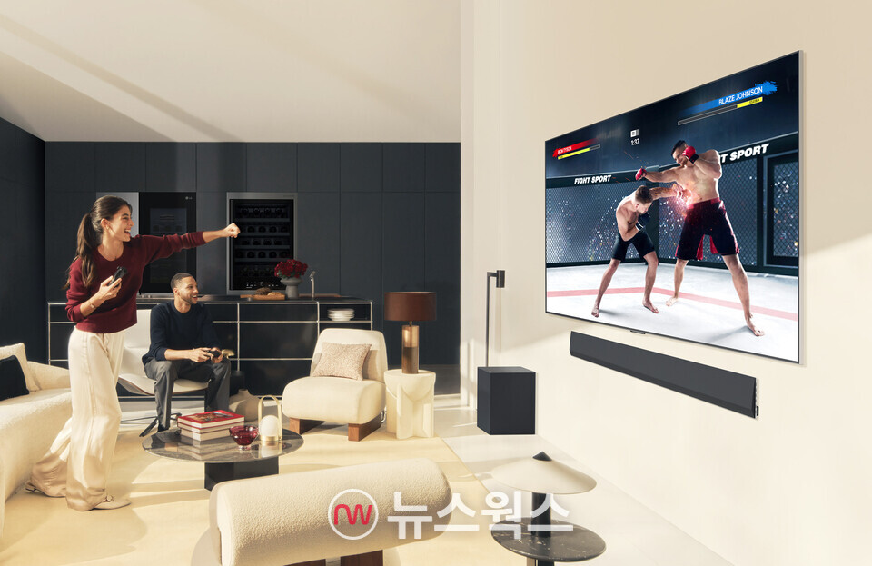 LG전자 모델들이 2024년형 LG 올레드 TV로 게임 콘텐츠를 즐기고 있다.. (사진제공=LG전자)