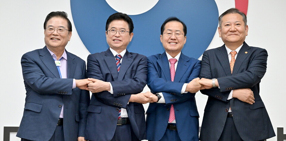 21일 정부서울청사에서 우동기(왼쪽부터) 지방시대위원장, 이철우 경북도지사, 홍준표 대구시장, 이상민 행정안전부 장관이 대구·경북 통합을 위한 공동 합의문에 서명하고 손을 맞잡고 있다. (사진제공=경북도)