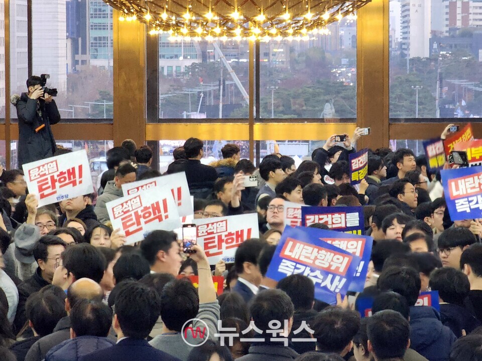 7일 국회의사당 안에서 더불어민주당 등 야당 관계자들이 윤석열 대통령을 탄핵하라는 구호를 외치고 있다. 의사당 정문 유리문 건너편으로 국회 앞 집회 참여 시민들이 보인다. (사진=박광하 기자)