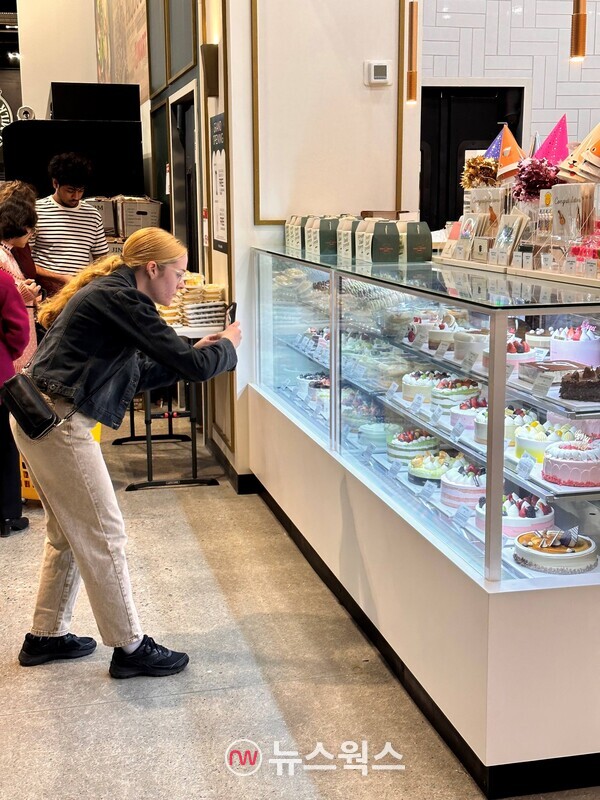 뚜레쥬르 캐나다 1호점을 방문한 고객이 케이크 제품을 촬영하는 모습. (사진제공=CJ푸드빌)