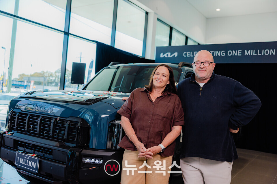 기아 호주 진출 이후 누적 판매 100만 번째 차량을 구매한 고객 안드레아 앨런도프(왼쪽)·제임스 앨런도프 부부가 타스만 듀얼 캡 모델 앞에서 포즈를 취하고 있다. (사진제공=기아)